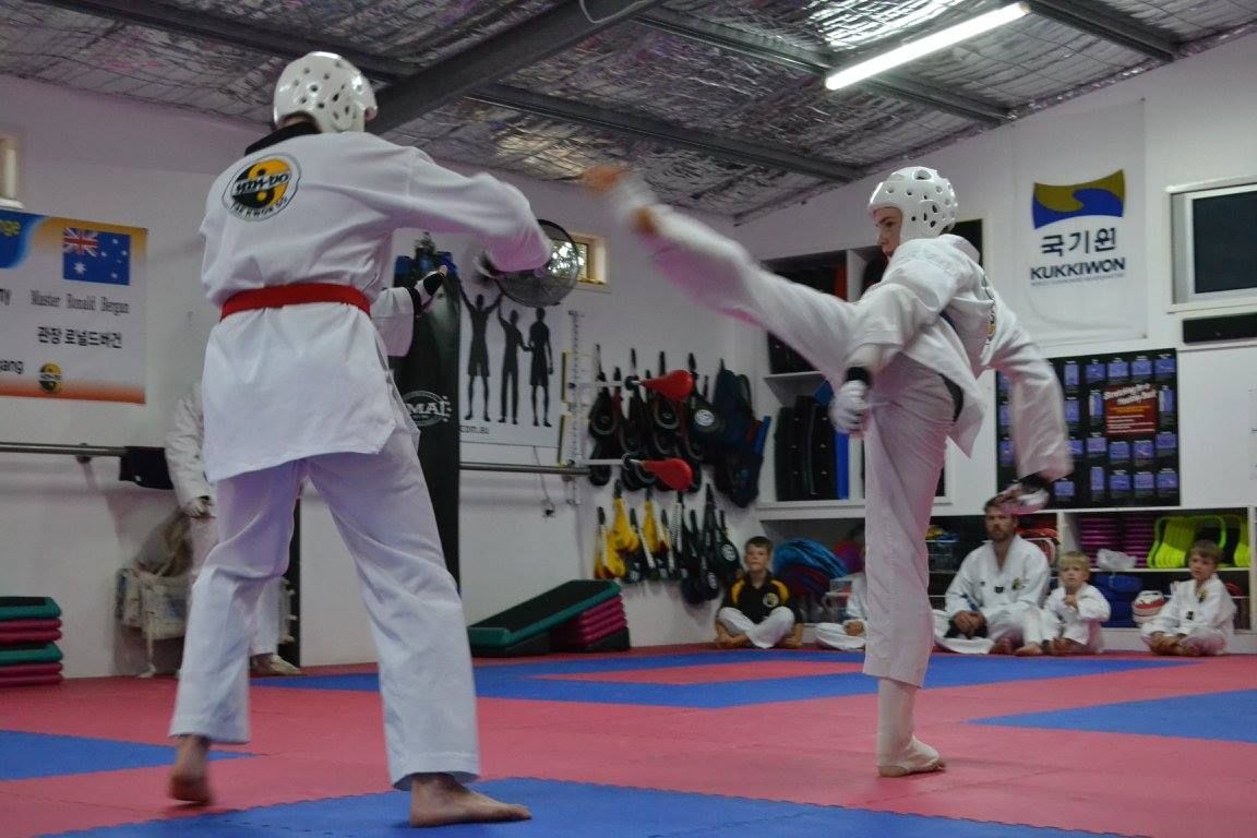 A Group of People Are Practicing Kicks in a Gym — Him-Do Tae Kwon Do Academy In Salamander Bay, NSW