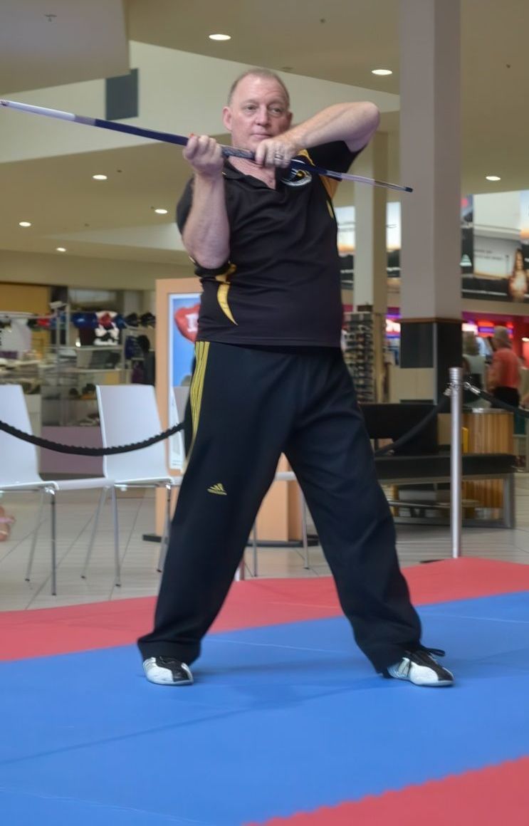 Man Holding a Sword Stance — Him-Do Tae Kwon Do Academy In Salamander Bay, NSW
