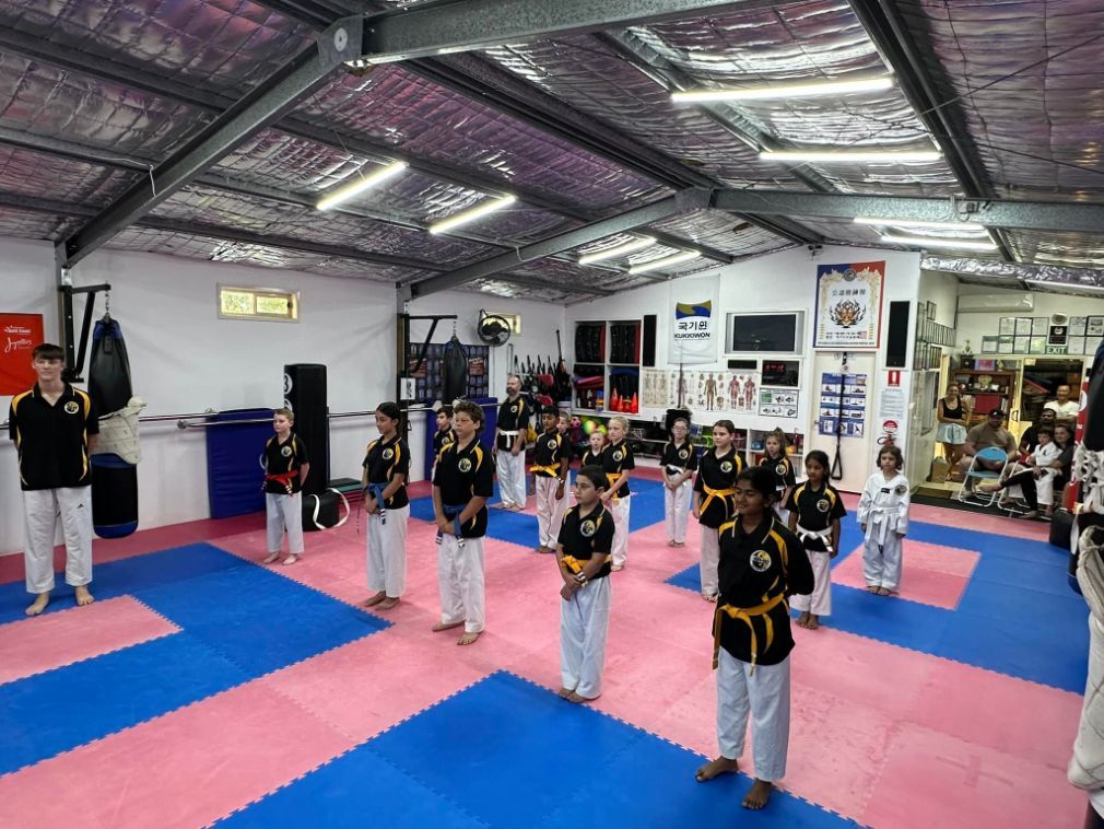 A Group of Children Are Practicing Martial Arts in a Gym — Him-Do Tae Kwon Do Academy In Salamander Bay, NSW
