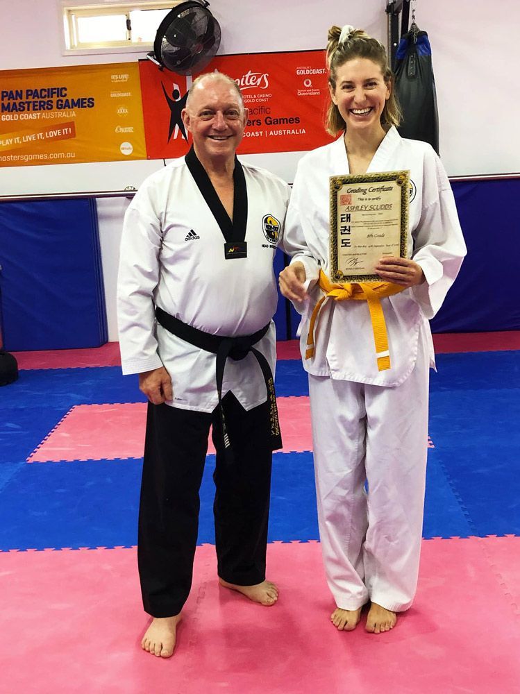 A Man and a Woman Are Posing for a Picture in a Martial Arts Gym — Him-Do Tae Kwon Do Academy In Salamander Bay, NSW