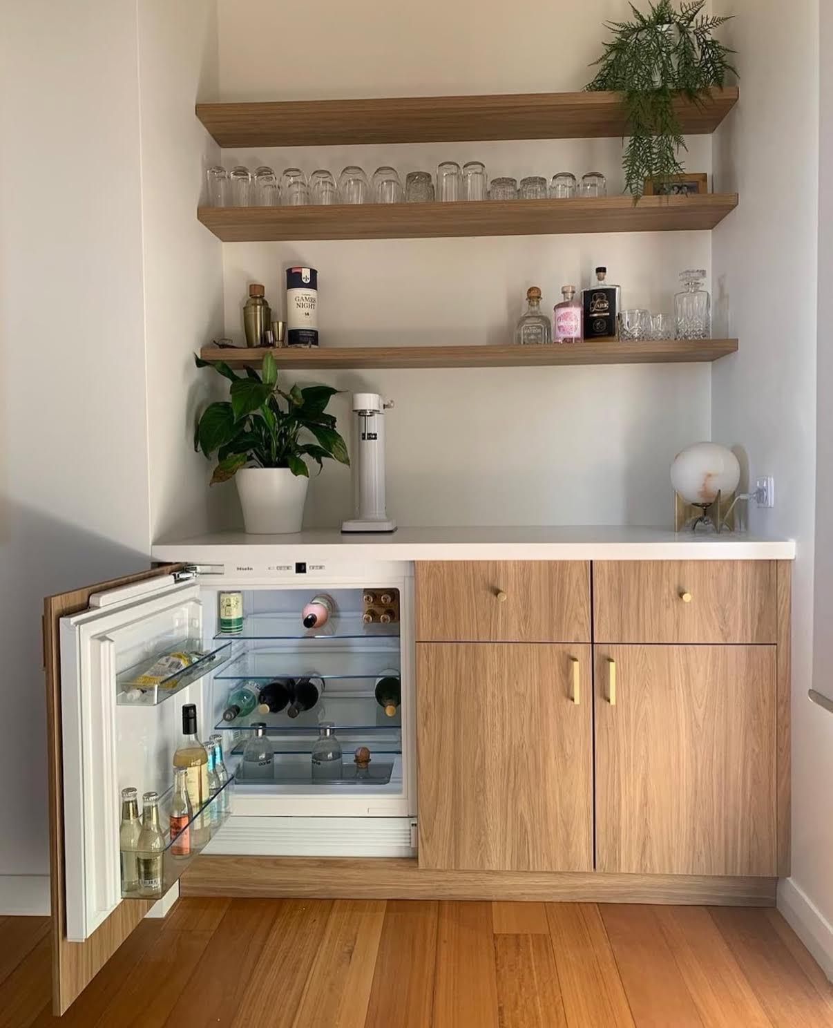 Custom bar cabinet with integrated fridge and floating shelves installed in Perth.