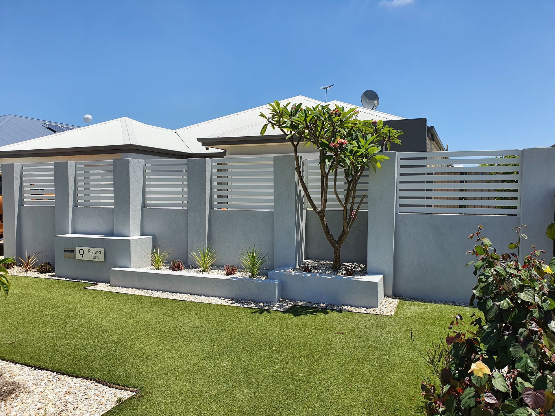 Boundary wall with aluminium slats build in Perth finished with grey texture coat.