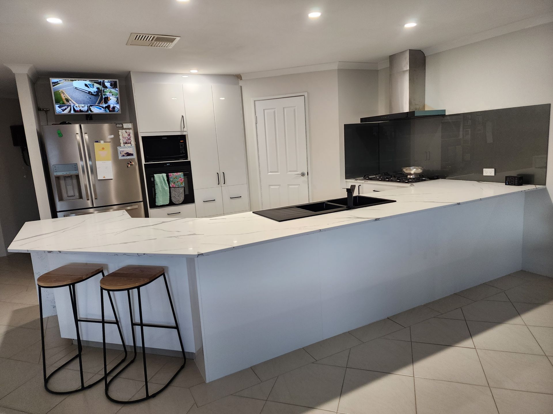 Modern white kitchen withmarble look stone bench top installed in Perth.