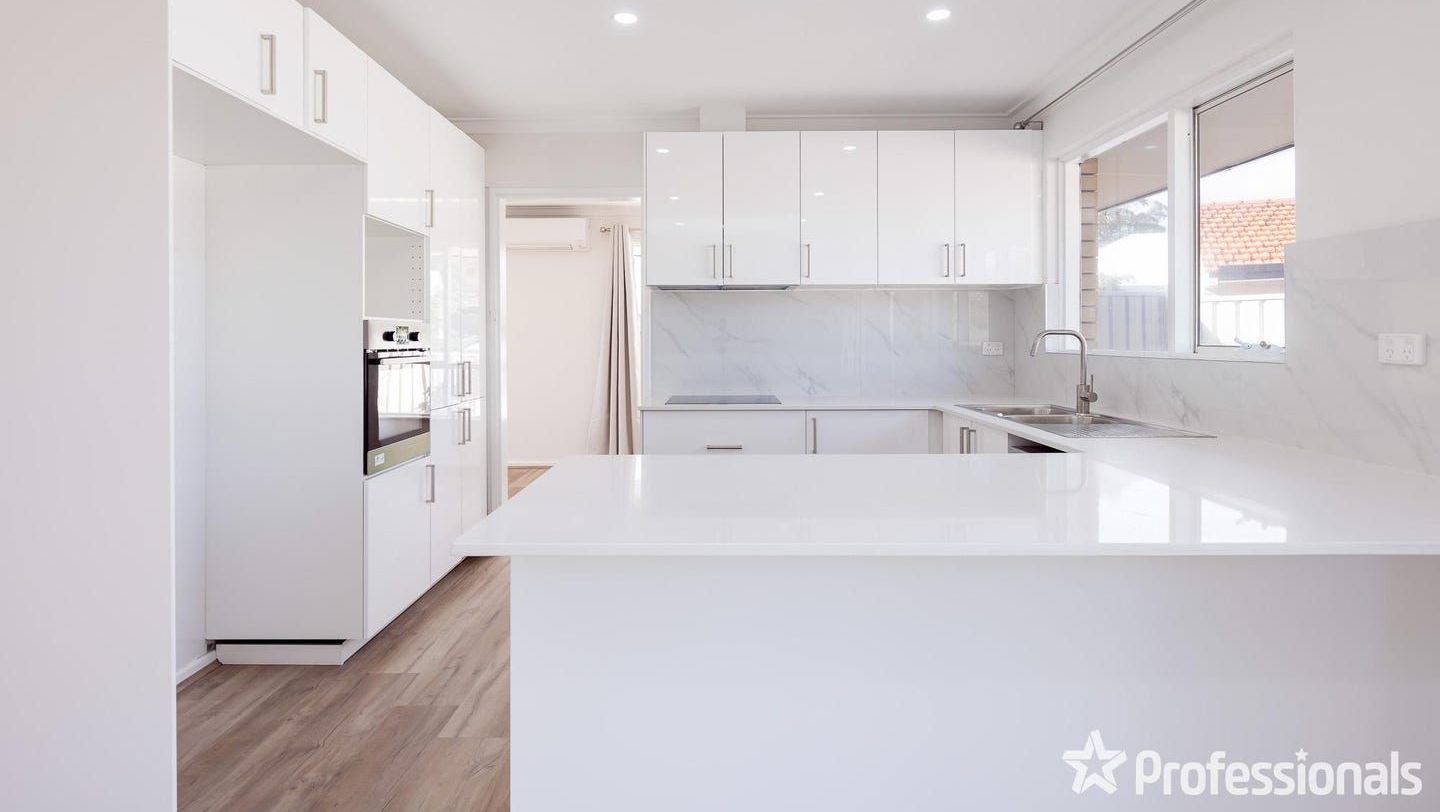 Modern white kitchen with stone bench top installed in Perth.