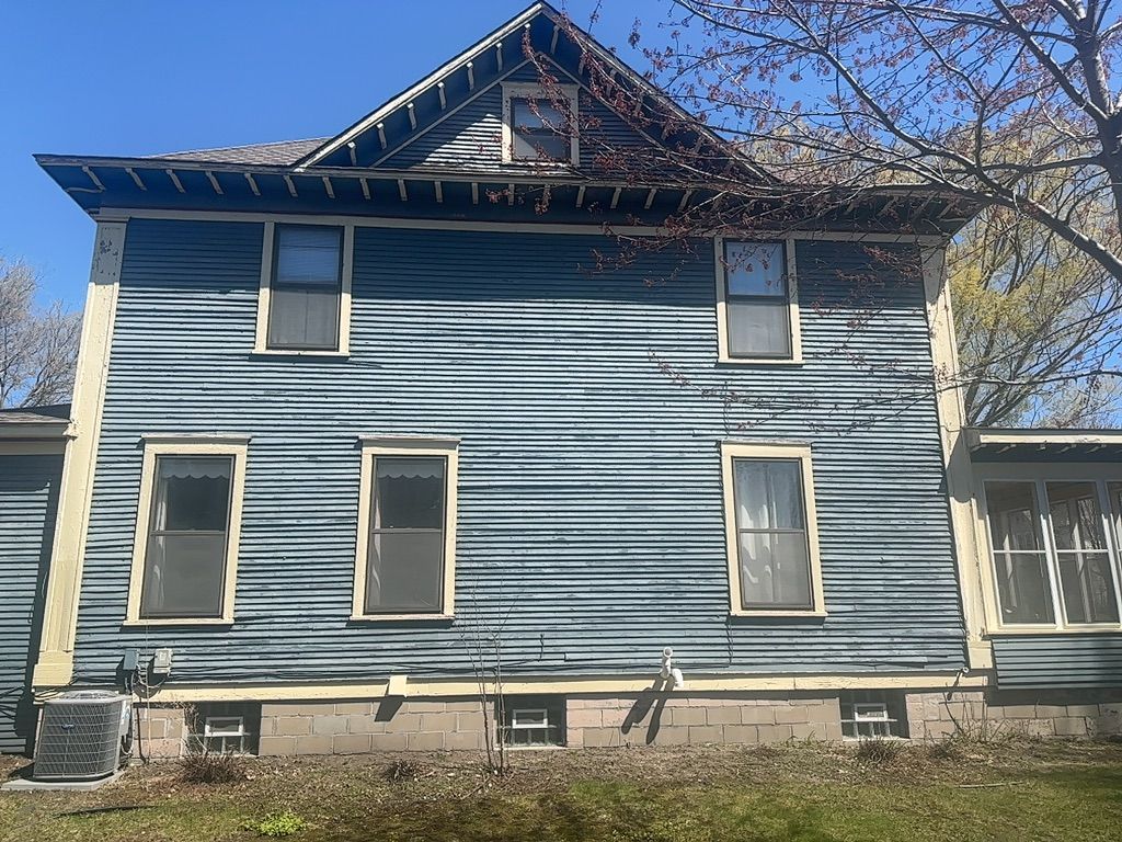 Side View of Blue House Before — Carver, MN — TJ Exteriors Inc.