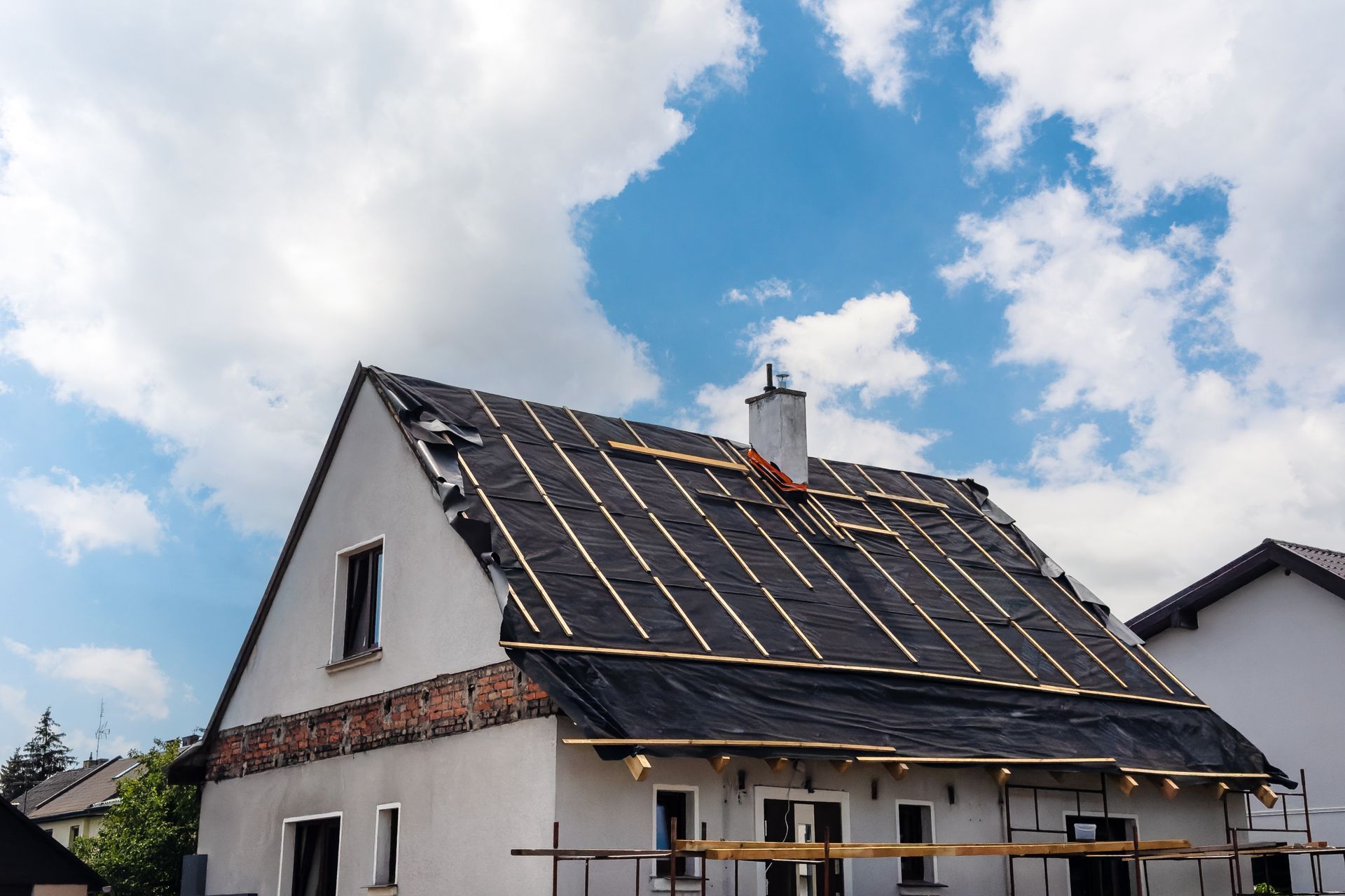 A house’s roof in the process of replacement.