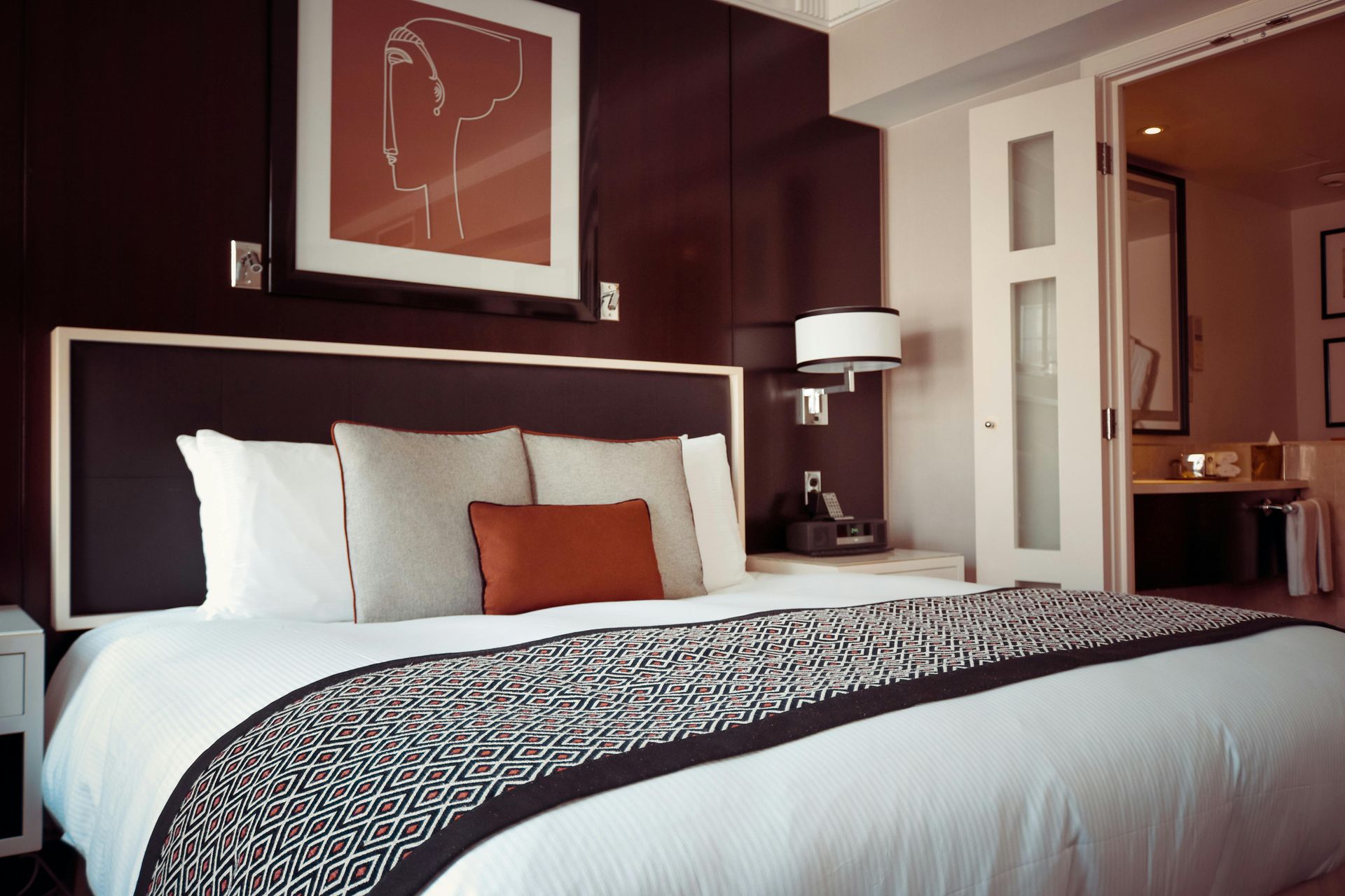 A hotel room with a bed and a picture on the wall