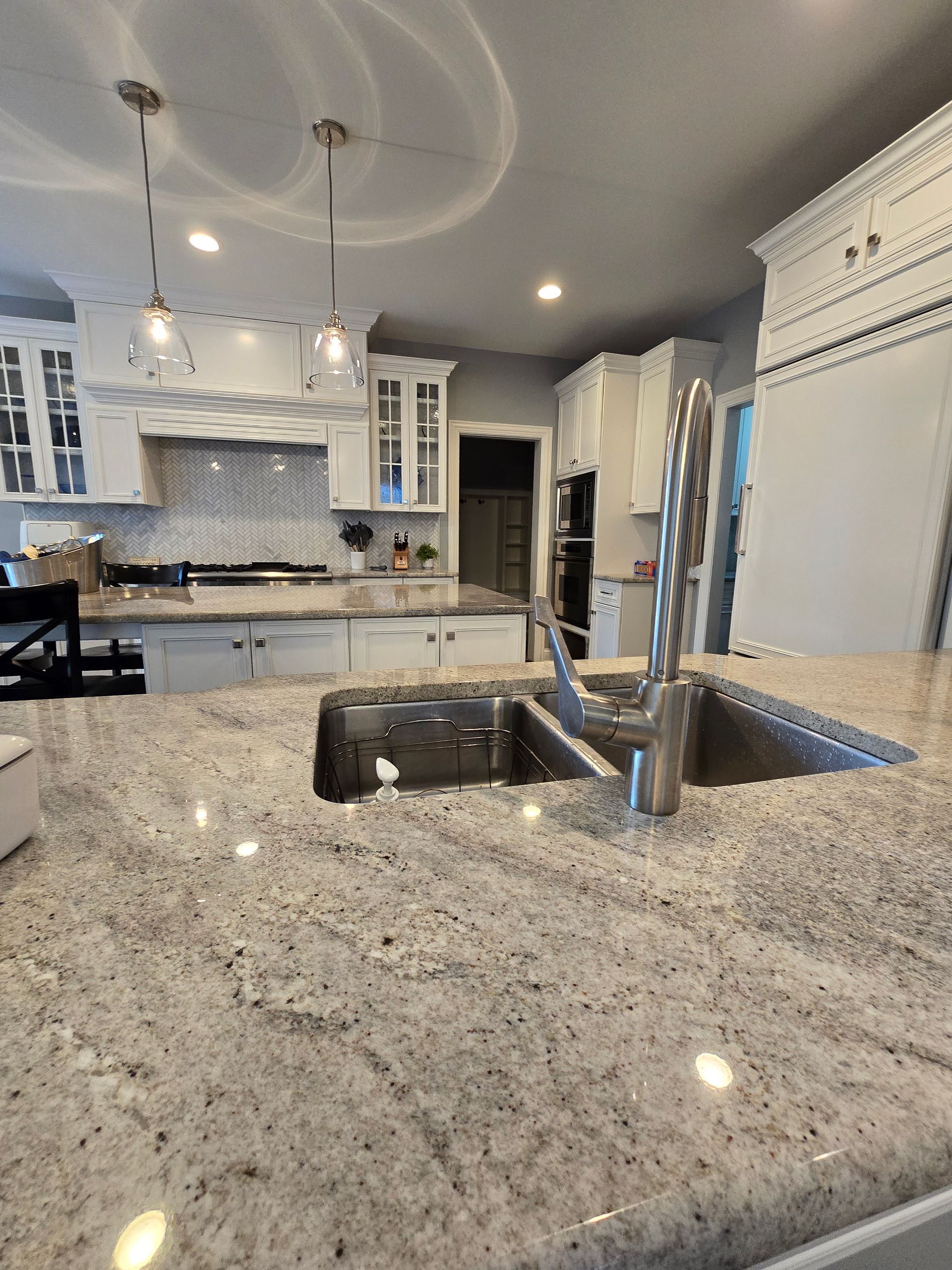 A kitchen with granite counter tops and a sink.