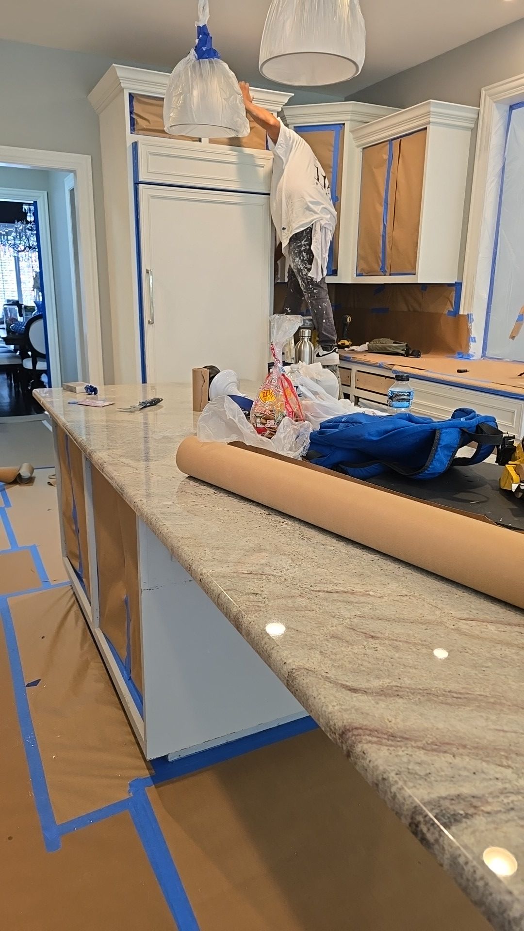 A kitchen under construction with a roll of paper on the counter.