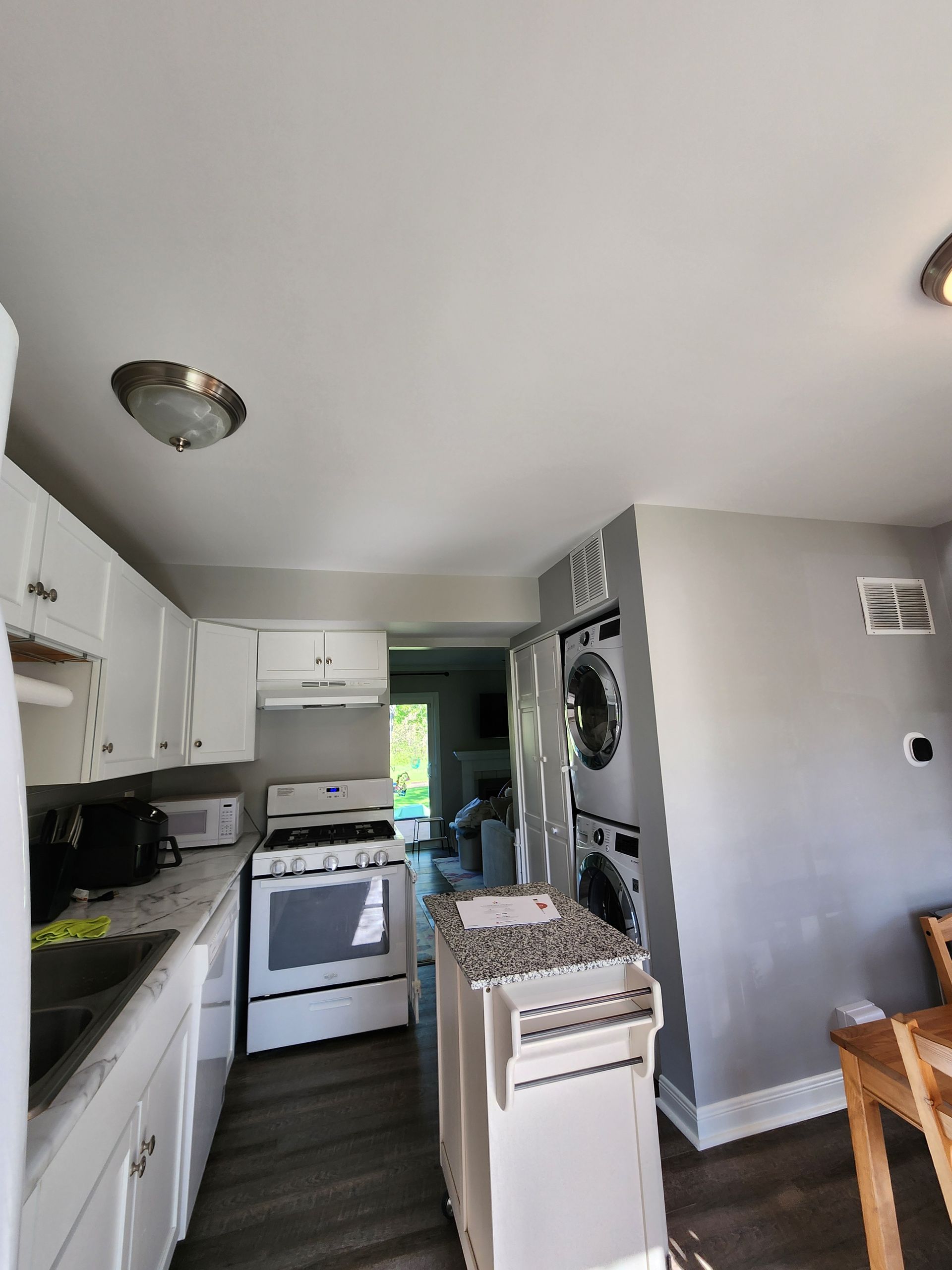 A kitchen with a stove and a washer and dryer