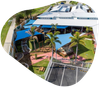 Aerial view of a daycare facility with blue shade sails, green grass, and a parking lot.