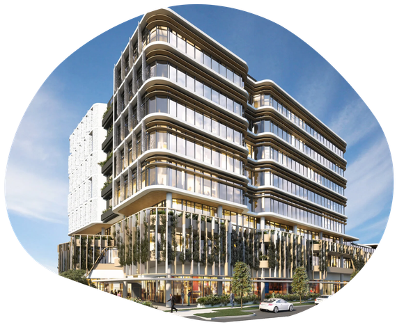 Modern office building with glass facade, curved edges, and retail space at the base.