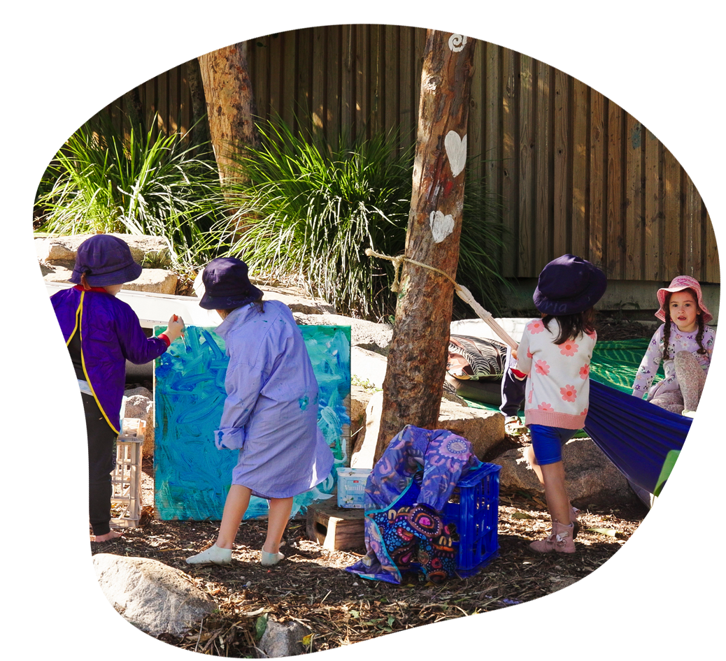 Children playing with water and metal containers outdoors.