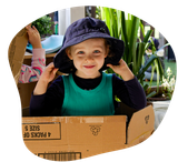 Child playing in cardboard box