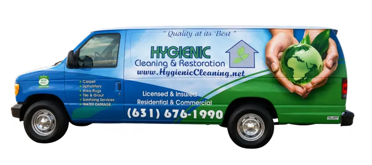 Blue and green A&M Cleaning and Restoration van with company text and phone number on the side