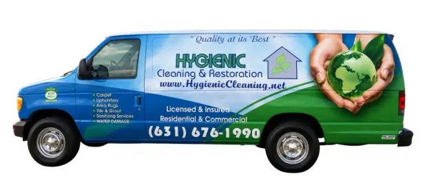Blue and green A&M Cleaning and Restoration van with company text and phone number on the side