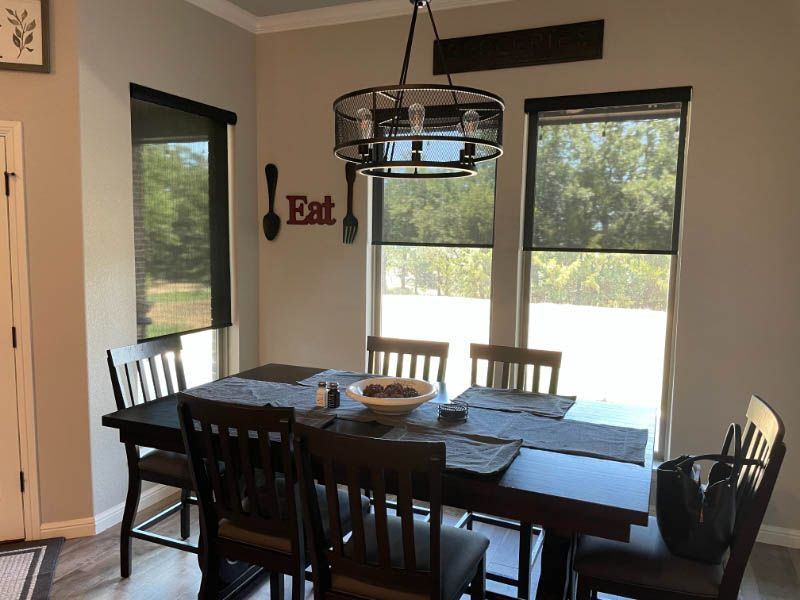 A dining room with a table and chairs and a sign that says eat