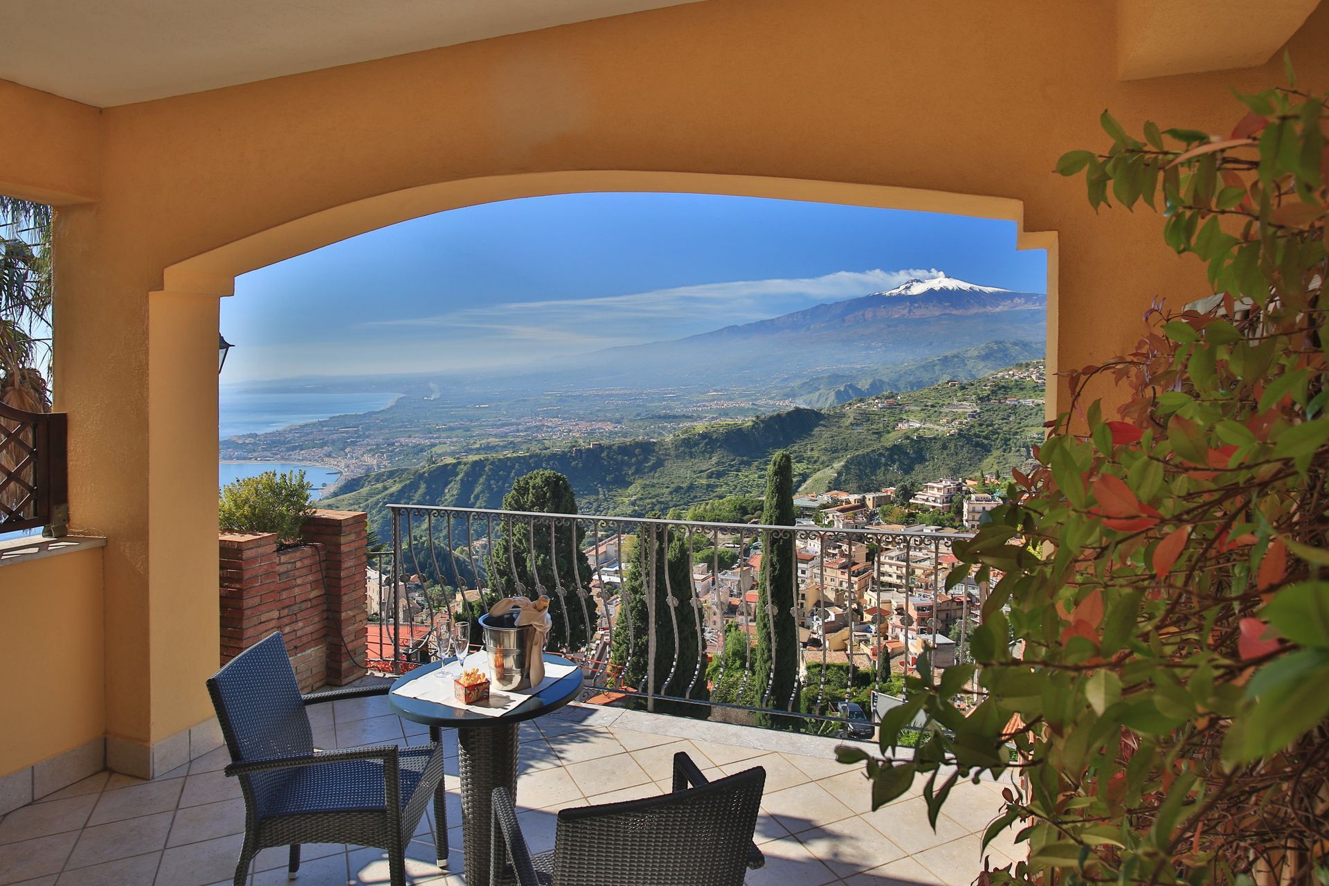 A balcony with a view of a city and mountains