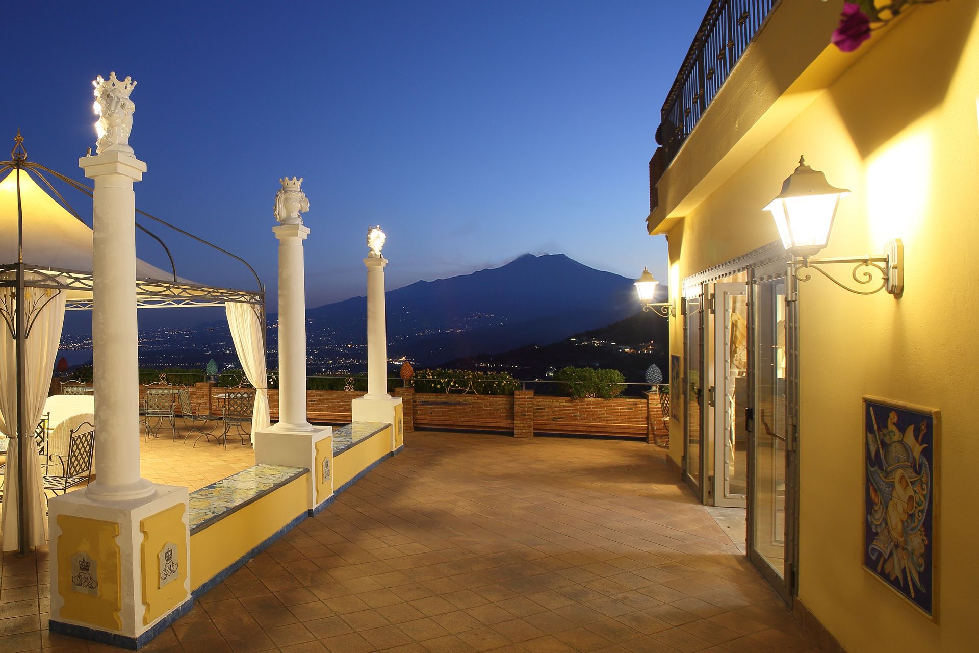 A balcony with a view of a mountain at night