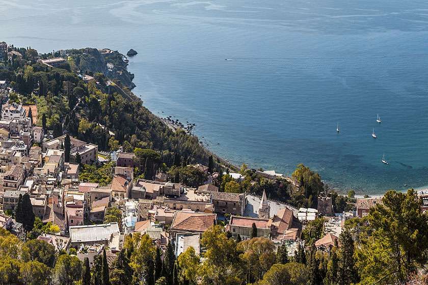 An aerial view of a small town next to a body of water.