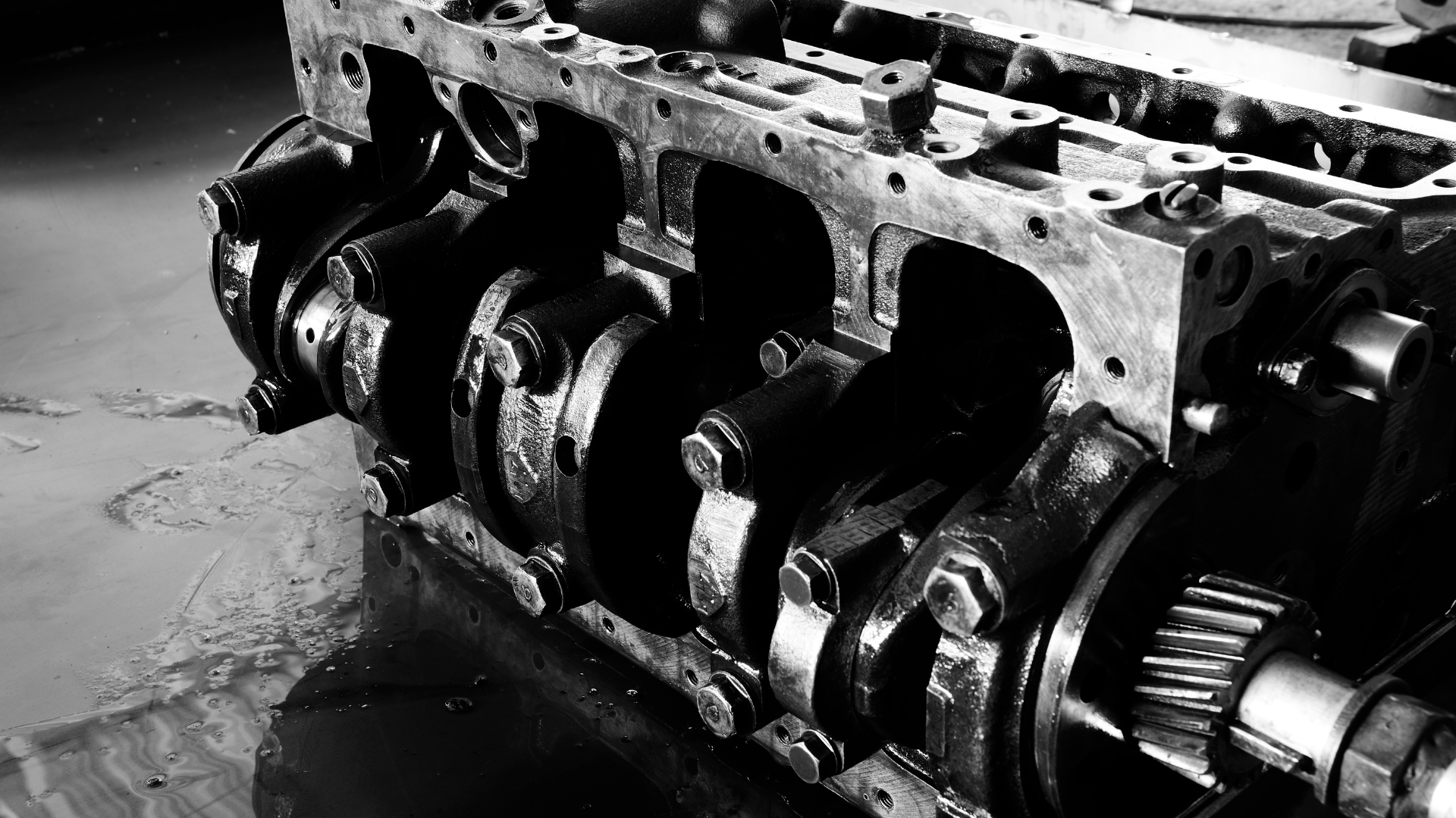 A black and white photo of a crankshaft of a car engine.