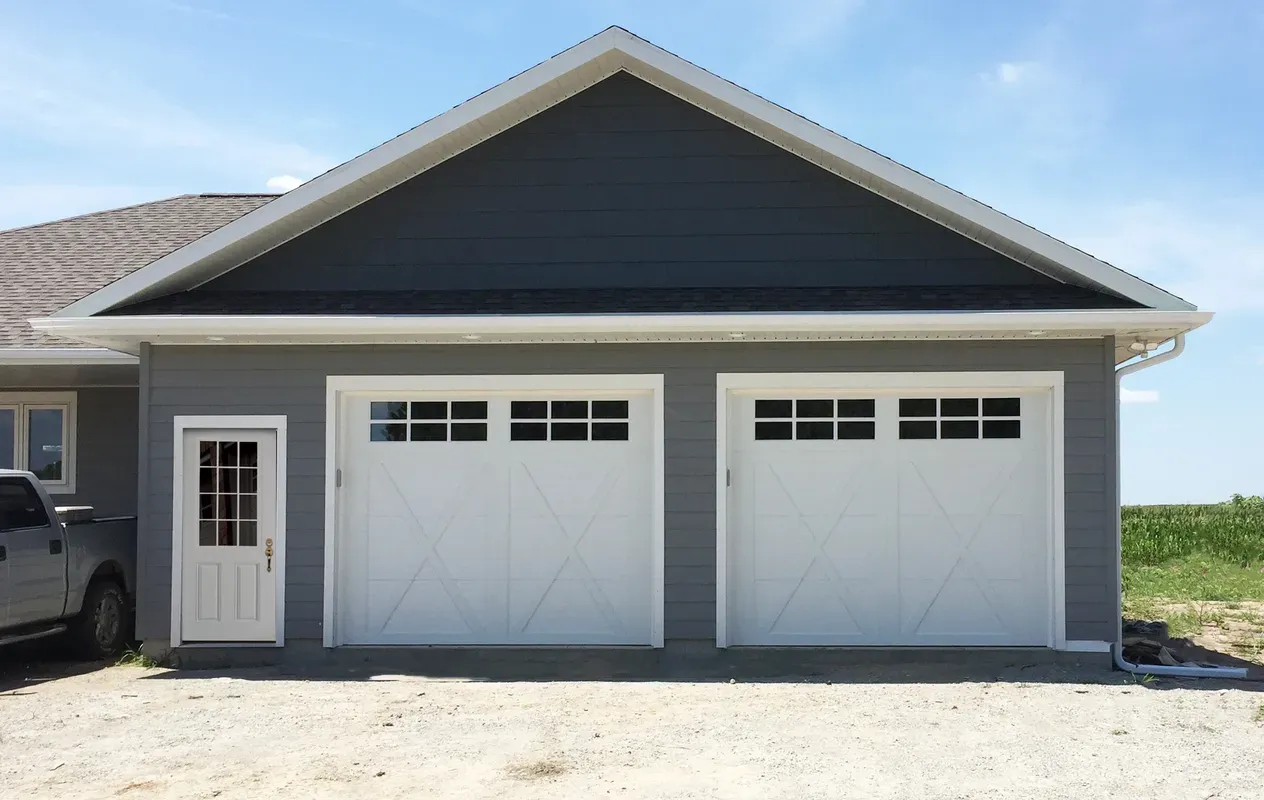Two Big White Garage Door And A Small Door — Beatrice, NE — Blue Valley Door Co. Inc.