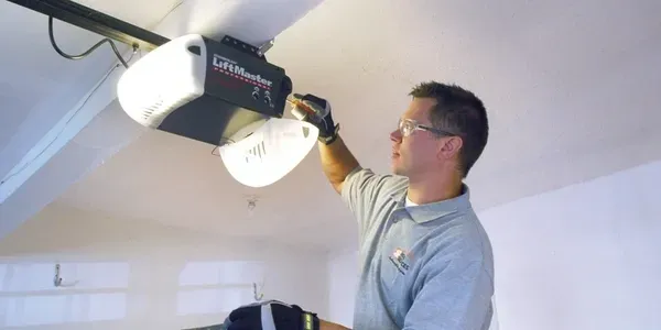 Man Installing New Garage Door — Beatrice, NE — Blue Valley Door Co. Inc.