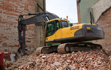 Yellow Truck Demolishing a Building — Deer River, MN — American Disposal Yellow Truck Demolishing a Building — Deer River, MN — American Disposal