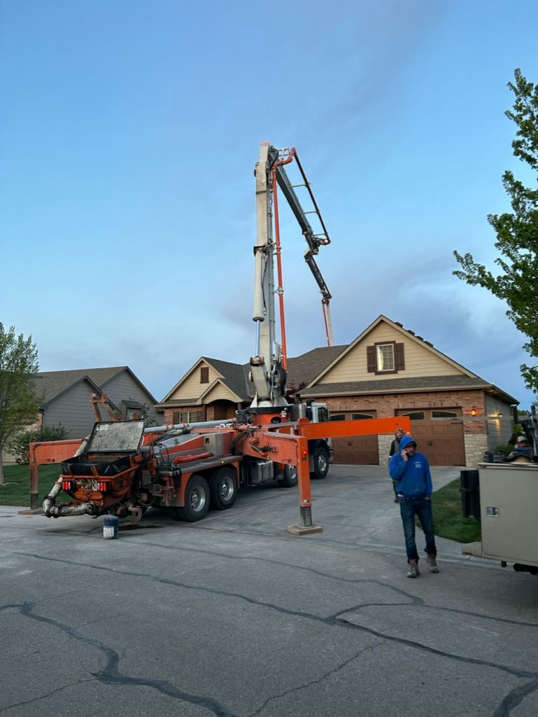 A man standing in front of a concrete pump truck