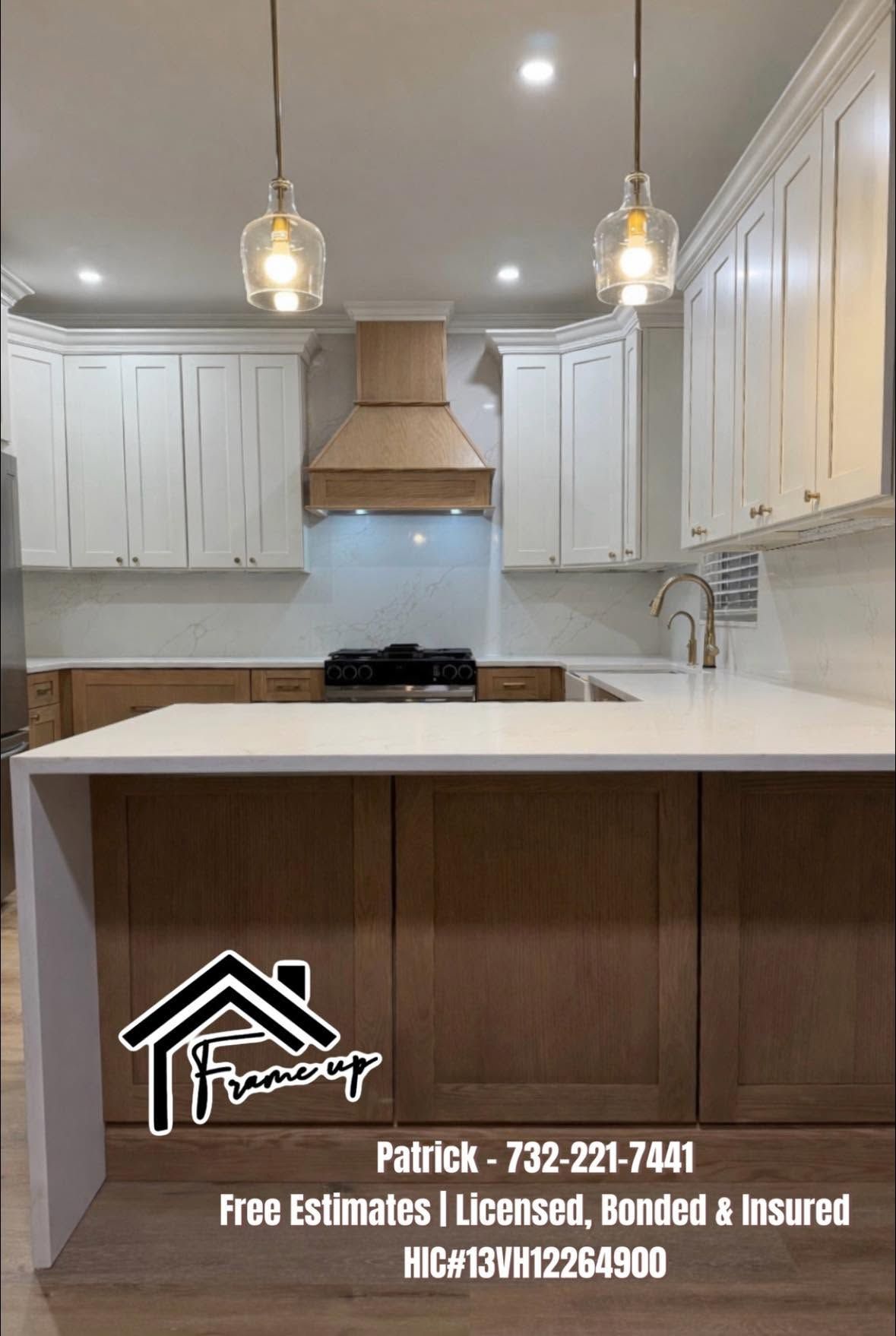 Bright white kitchen with island, pendant lights, and stainless range hood