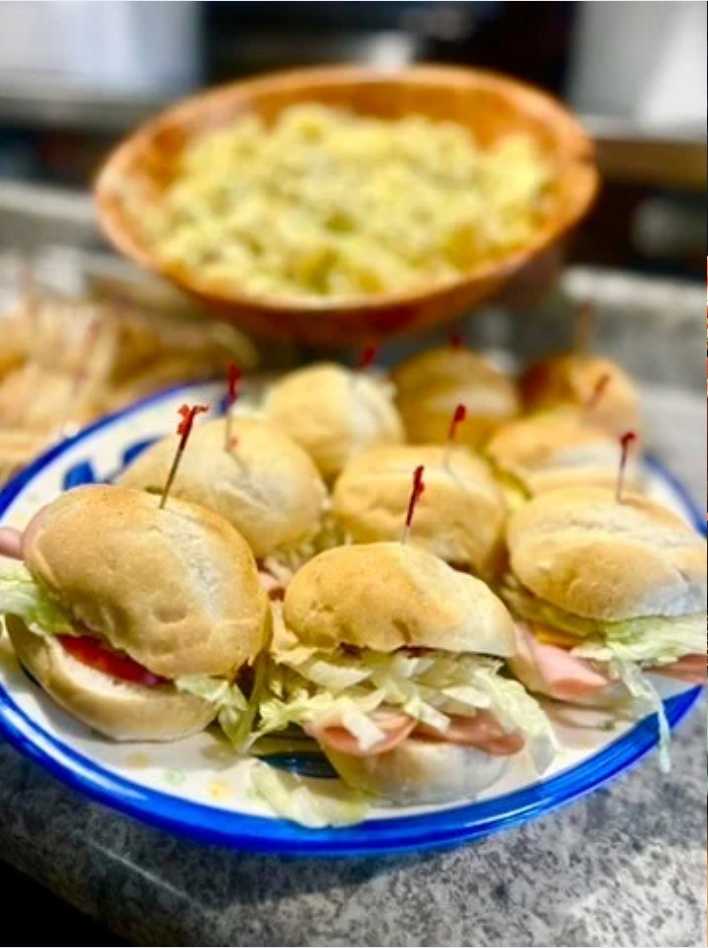 A plate of sandwiches with toothpicks in them on a table.
