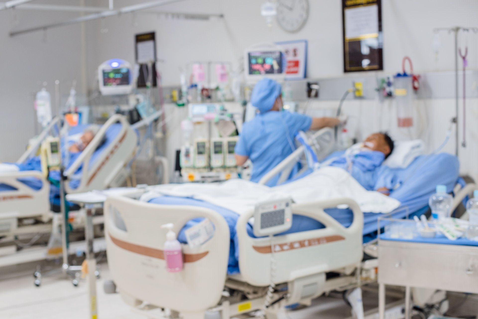ICU bed in a hospital surrounded by nurses