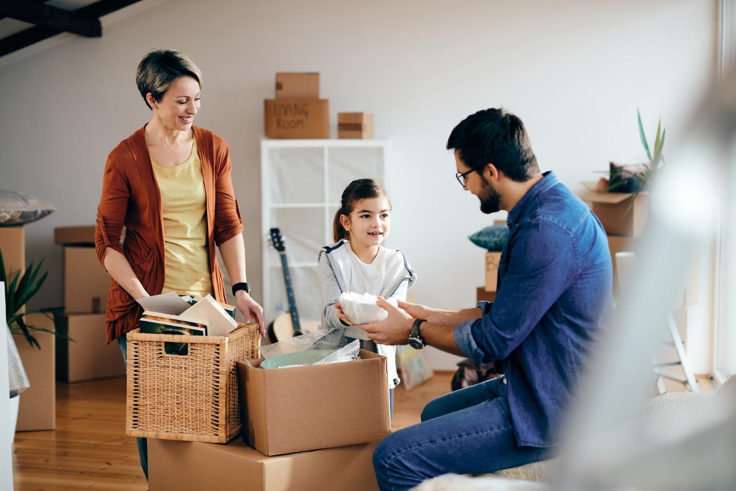 Family unpacking boxes in a new home. Parental Relocation Law Attorney in Nashville, Tennessee