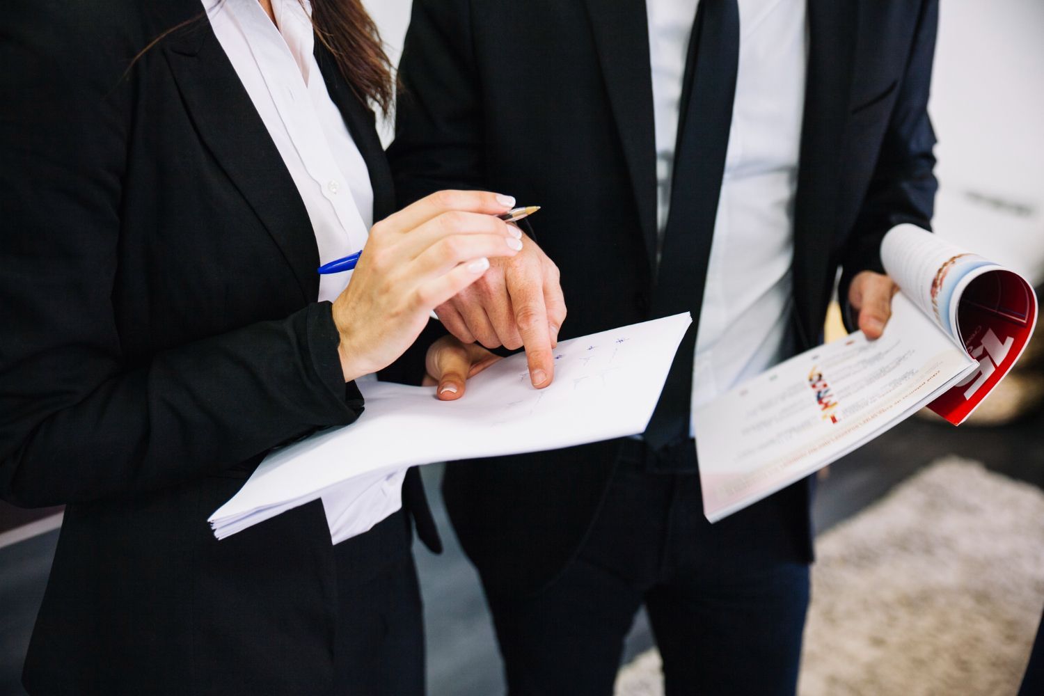 Two people in business suits reviewing papers, one pointing. Orders of Protection Law Attorney in Nashville, Tennessee