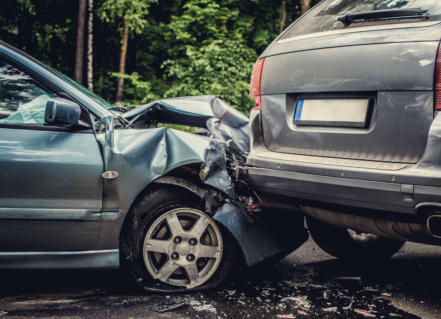 Two cars crashed, gray car rear-ends a blue car. Damage to front of blue car. Vehicular Assault Law Attorney in Nashville, Tennessee