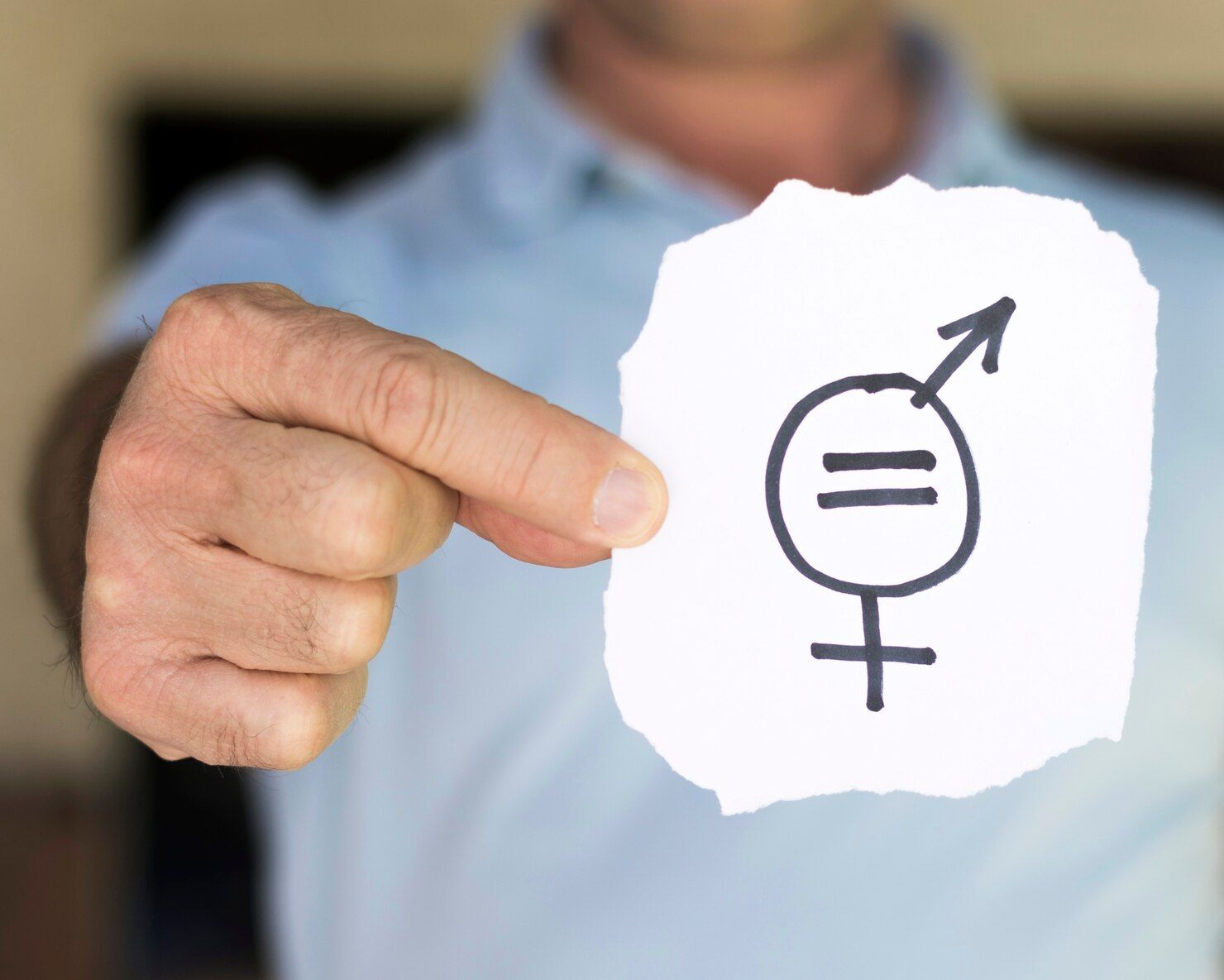 Person holding paper with gender equality symbol. Equal Pay Litigation Law Attorney in Nashville Tennessee