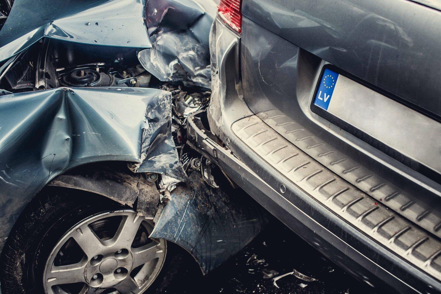 Two damaged cars after a collision; blue car front crumpled, gray car rear bumper damaged. Reckless Driving Law Attorney in Nashville, Tennessee