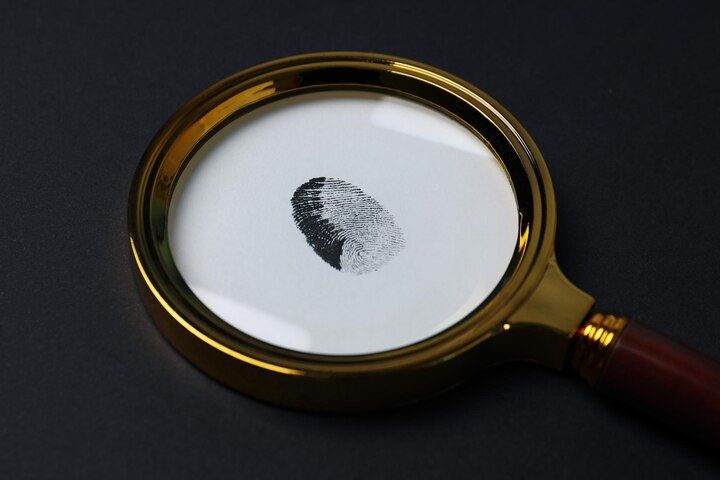 Magnifying glass over a fingerprint. Identity Theft Law Attorney in Nashville Tennessee