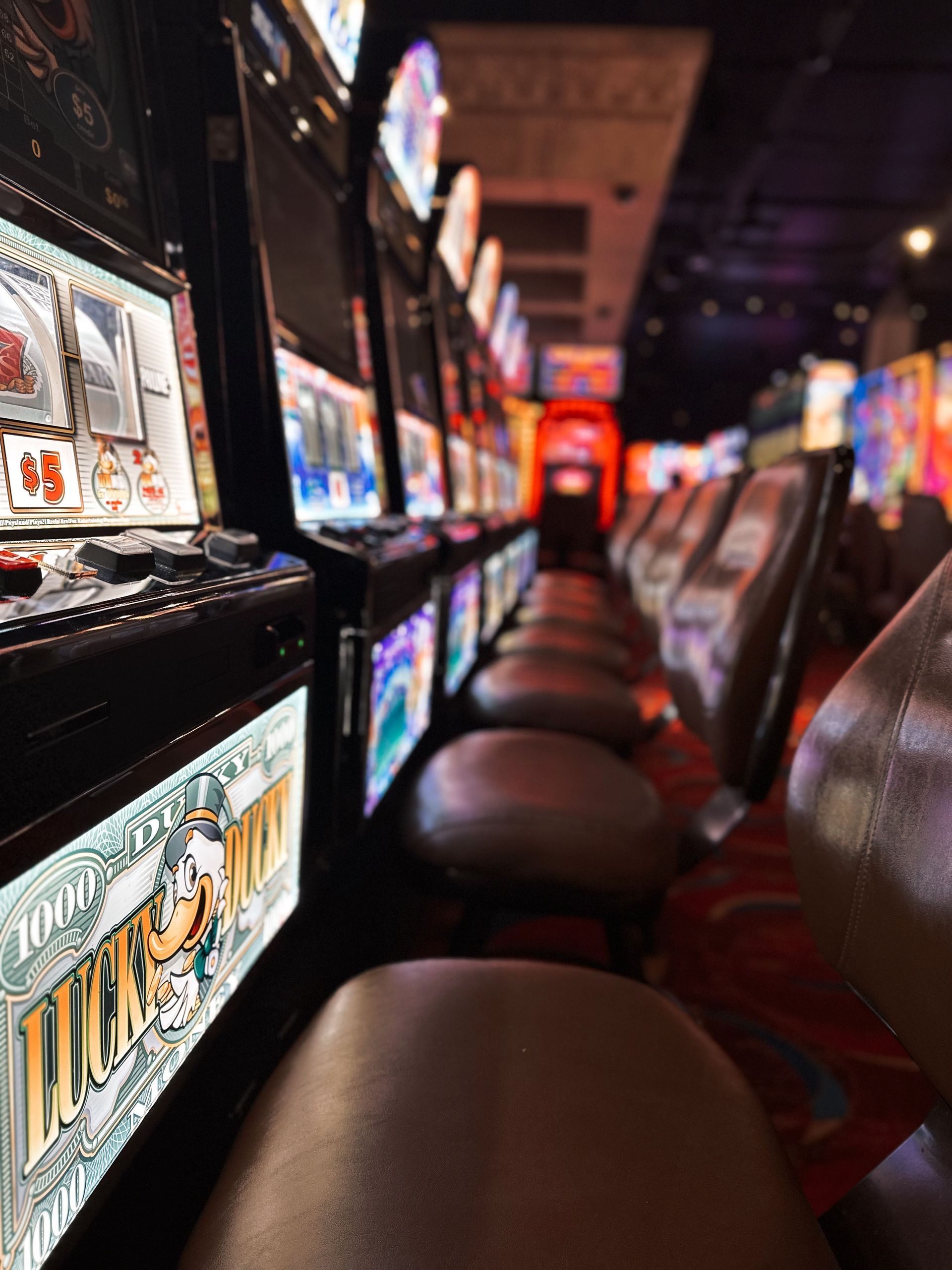 Row of electronic gaming machines in a dim room, for a post on Tennessee gambling device laws