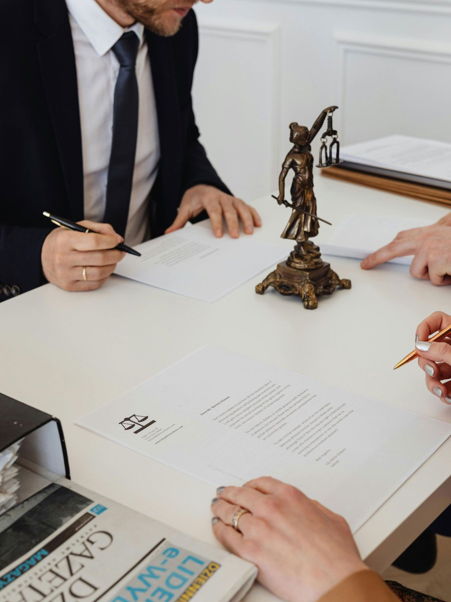 People at a table, signing documents. Civil Litigation Practice Areas in Nashville, Tennessee