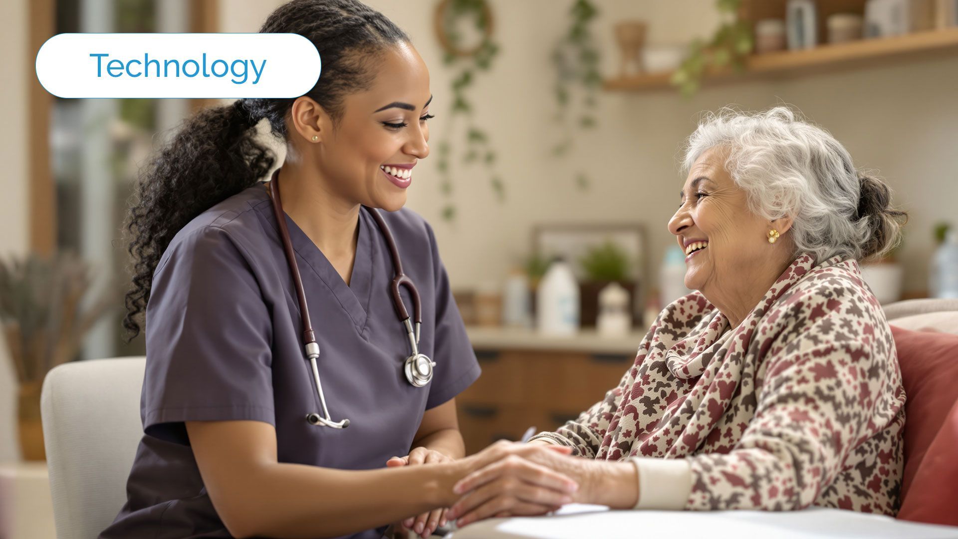 A healthcare worker smiling while holding hands with an elderly person in a home setting.
