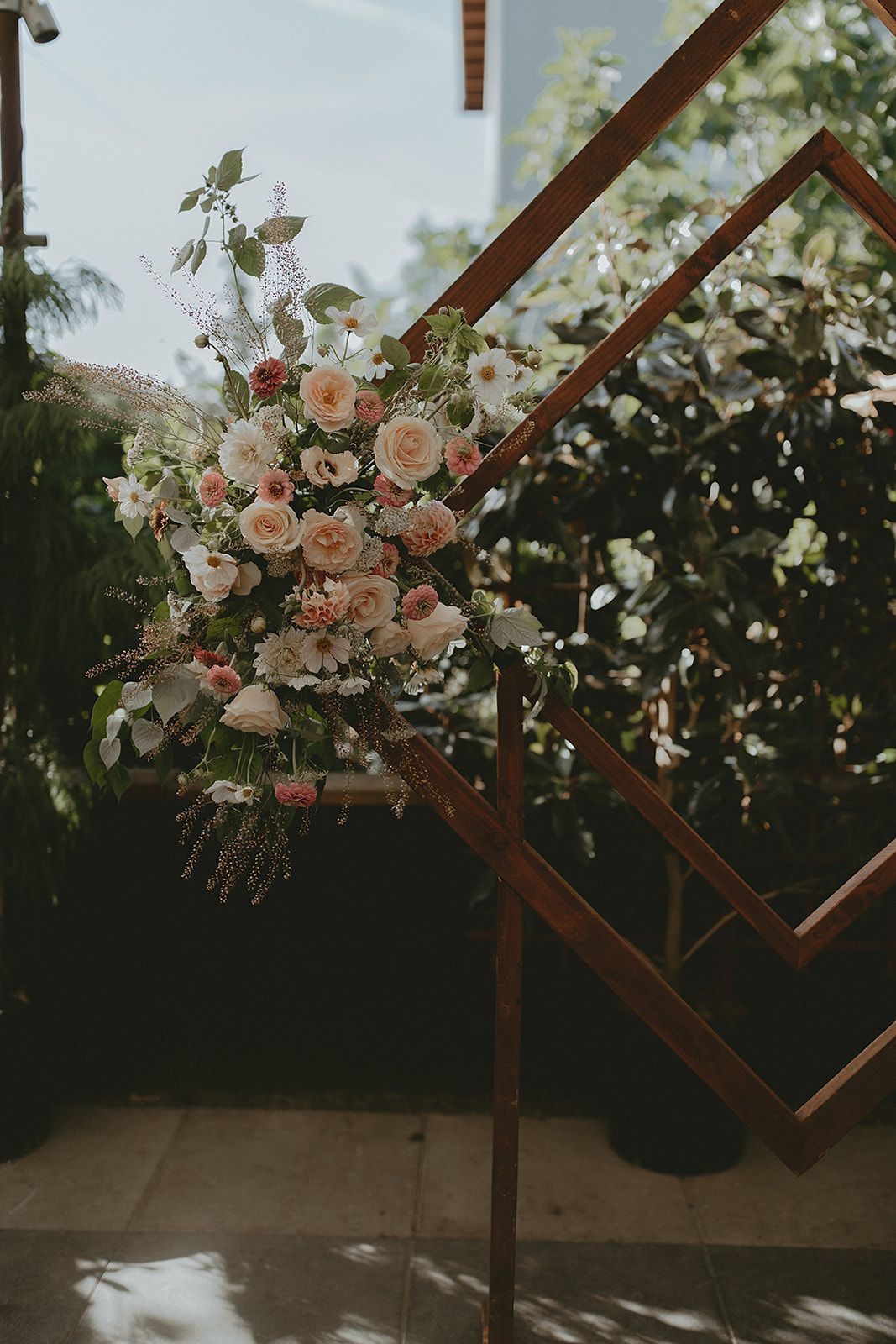 Flowers on a diamond shaped wooden arch. 
