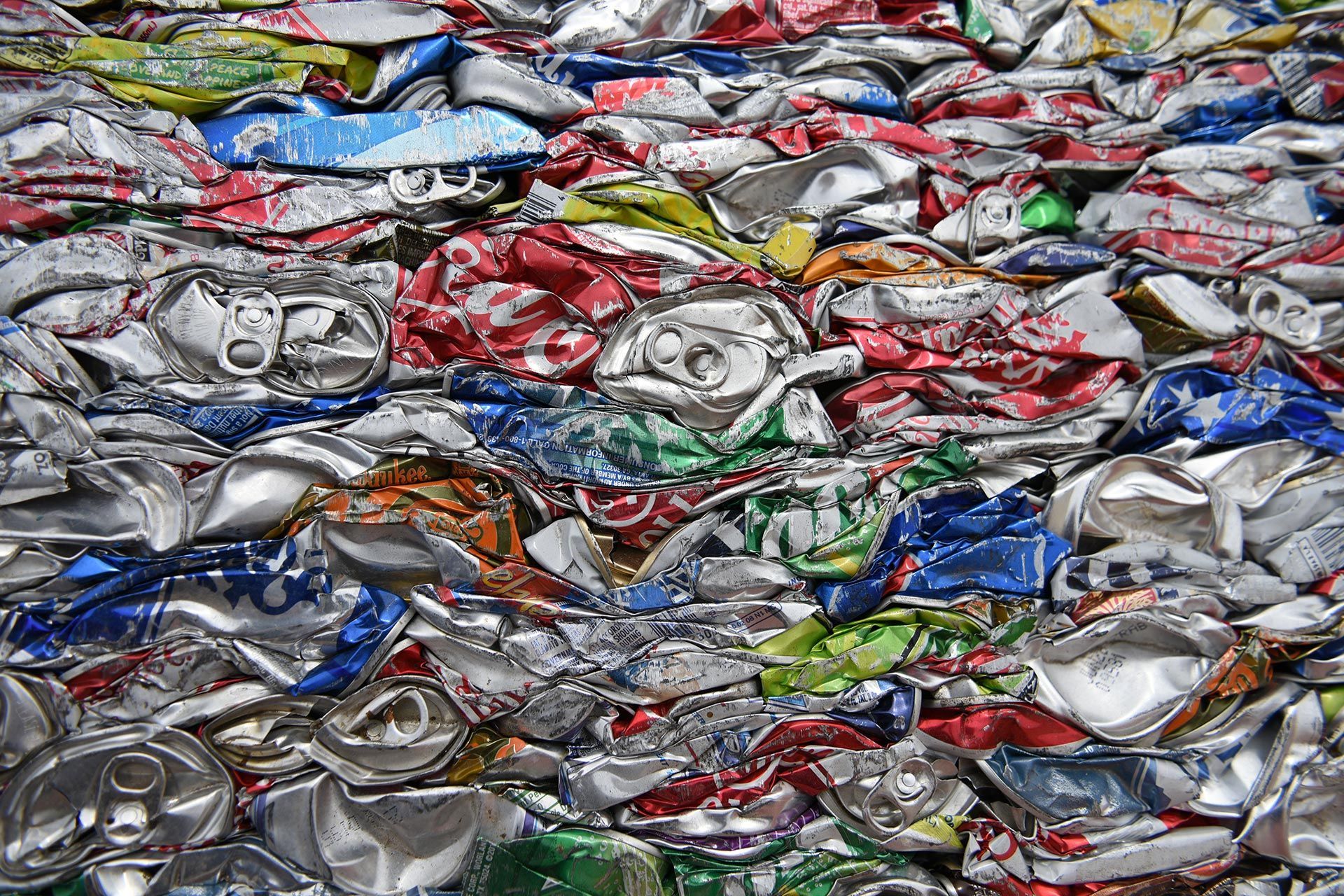 Crushed aluminum cans stacked for scrap metal recycling. Crushed aluminum cans stacked for scrap metal recycling.