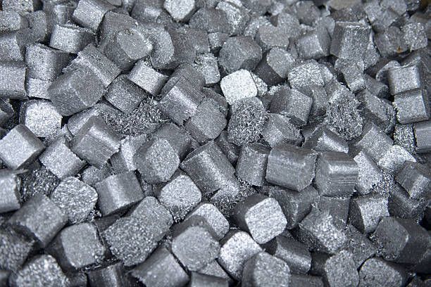 Close-up of aluminium scrap in recycling plant, highlighting sustainable aluminium recycling process.