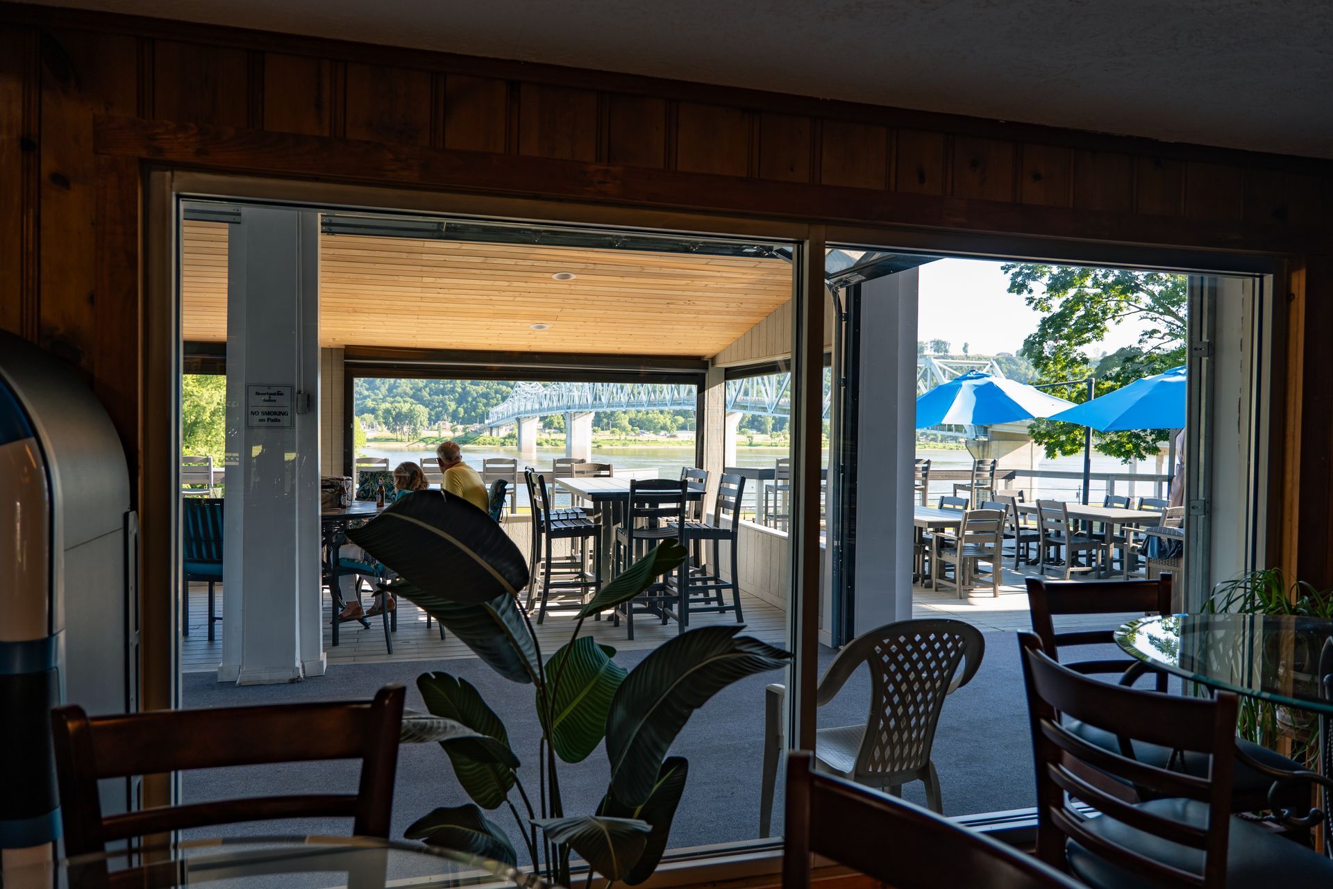  a patio with blue umbrellas and tables