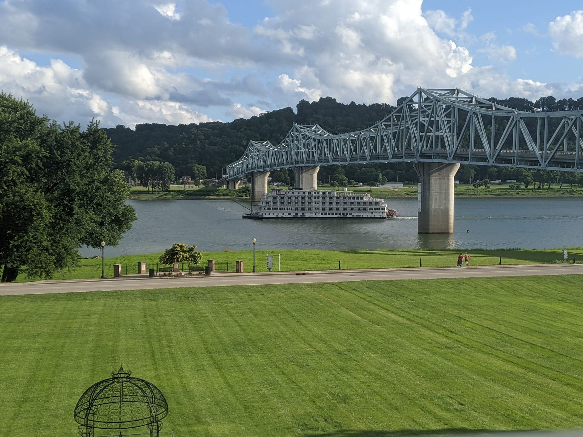 A bridge over a river with a boat in the water