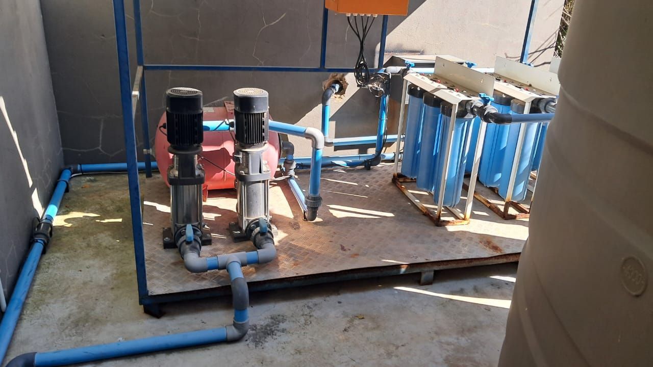 A room with a lot of blue pipes and pumps