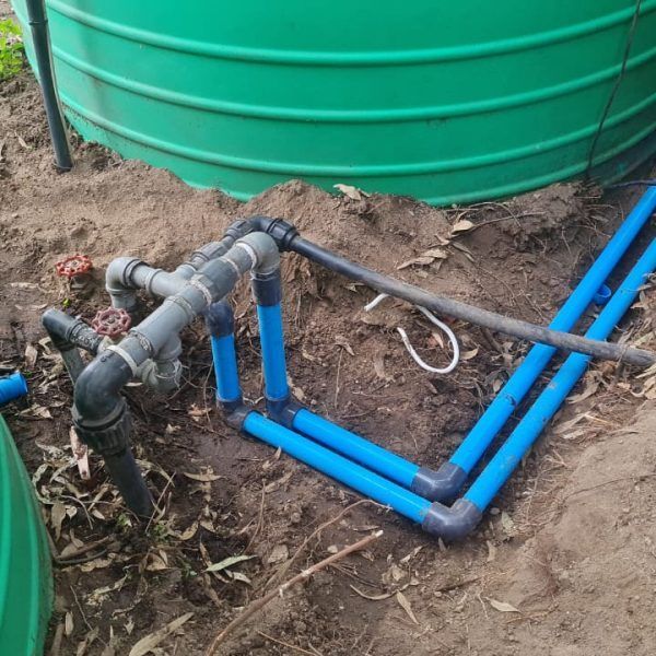 A green tank with blue pipes attached to it