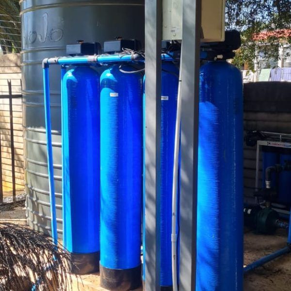 A row of blue water filters sitting next to each other