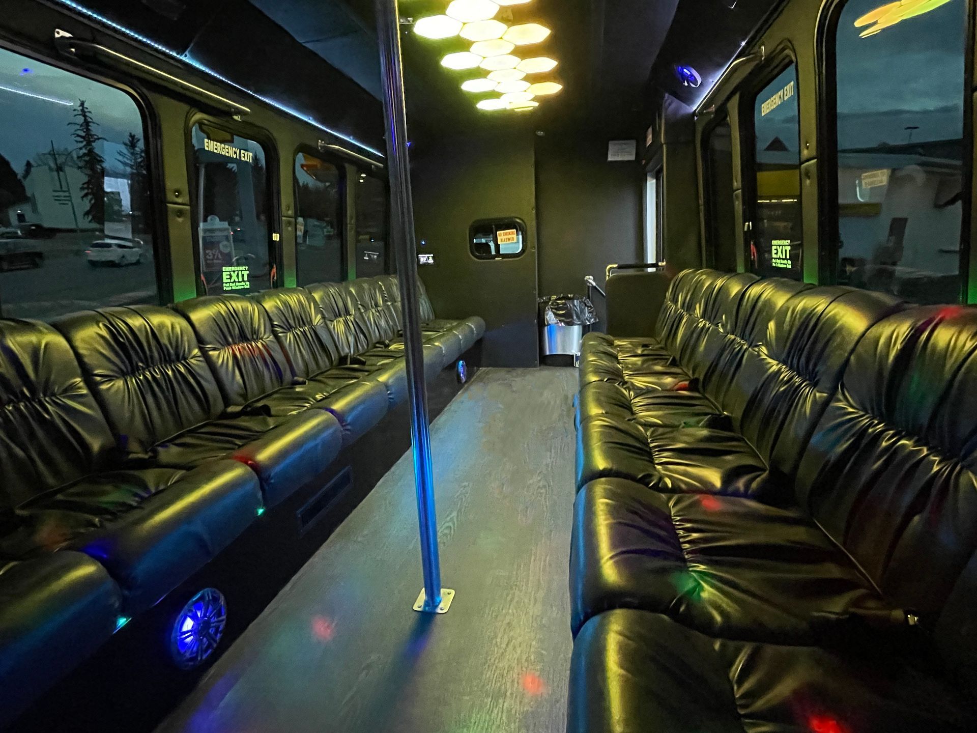 the inside of a limo to go party bus with emergency exit written on the door